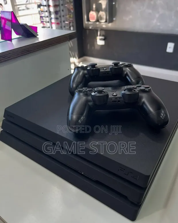 Sony PlayStation 4 Pro with 15 Games & 2 Controllers - 1