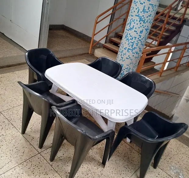 White Oval Dining Table with 6 Molded Plastic Arm Chairs - 1