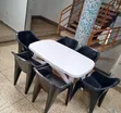 White Oval Dining Table with 6 Molded Plastic Arm Chairs - 1