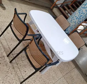 White Oval Dining Table with 4 Rattan Chairs