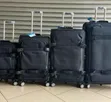 4-Piece Black Softside Rolling Upright Suitcase Set - 1