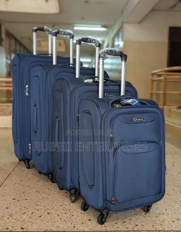 Four-Piece Navy Blue Softshell Spinner Suitcase Set - 1