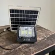 Brand New 200W Solar Flood Light with Panel & Remote - 1