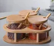 3-Piece Rotating Condiment Set with Clear Jars and Wooden Accessories - 1