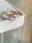 Oval-Cut Rose Gold Engagement Ring with Graduated Side Stones - 1