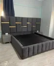 Upholstered Bed with Gold Strips and Side Tables - 1